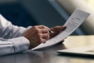 businessman-reading-documents-student loans without cosigner ss FEATURE